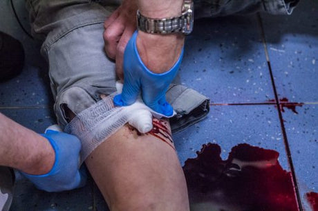 Bandaging Bleeding arm with gauze