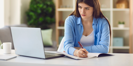 Young brunette nursing student taking notes from simplenursing coursework nclex changes 2023