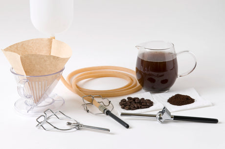 Enema Tools with coffee beans and coffee in a glass cup