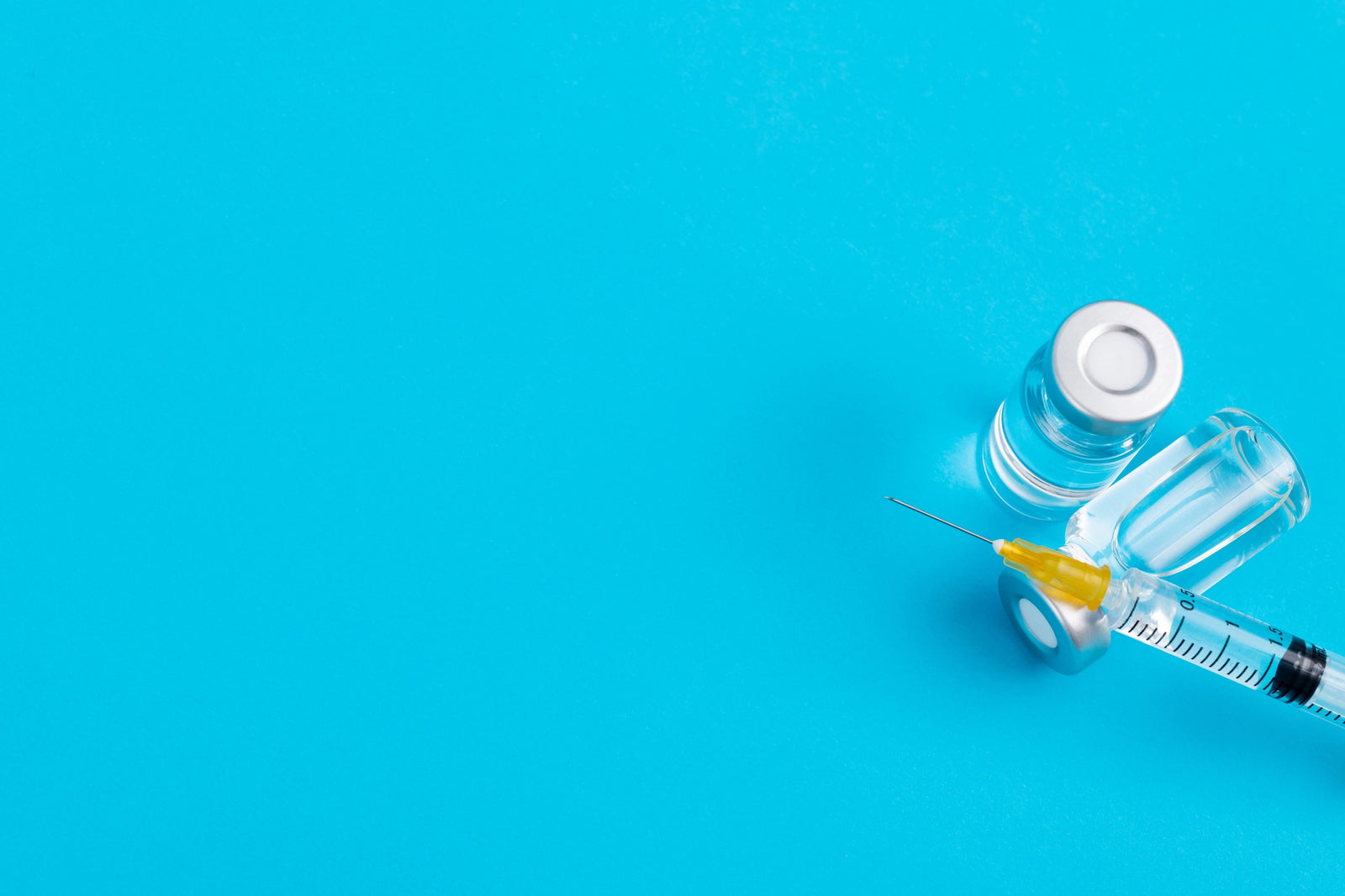 Insulin vial & syringe on a blue background