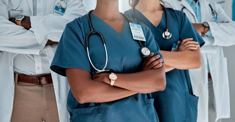 LPN and RN standing in between 2 doctors with hospital badges