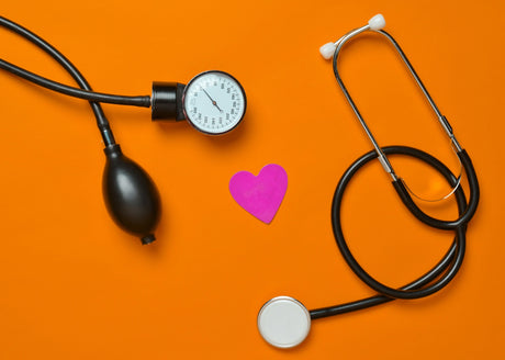 Manual Blood Pressure cuff with Stethescope on an orange background