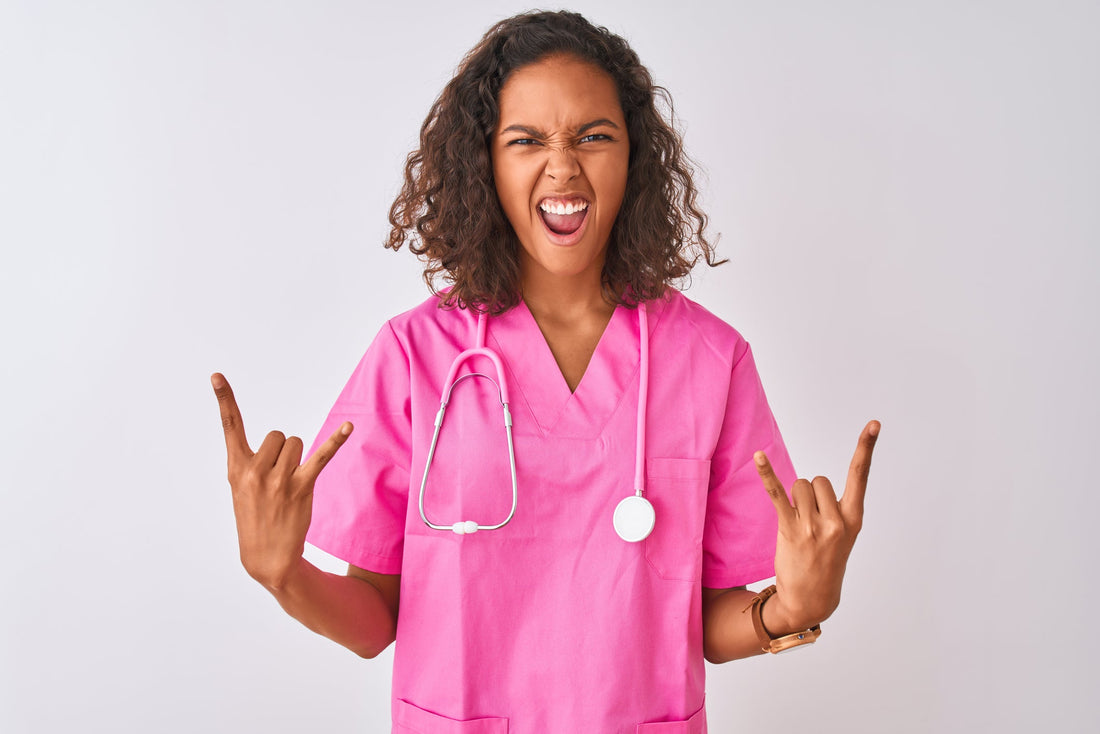 Young brazilian nurse woman wearing stethoscope standing over isolated white background shouting with crazy expression doing rock symbol with hands up.