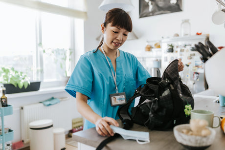 Nurse packing bag in kitchen