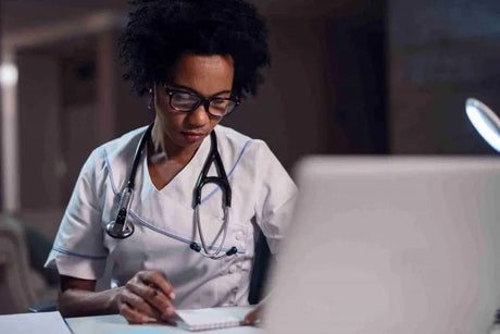 Black female nurse in white scrubs and black framed glasses what is the teas test