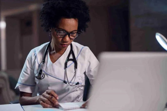 Black female nurse in white scrubs and black framed glasses what is the teas test