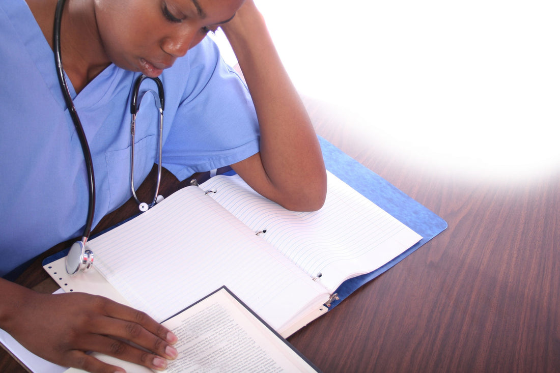 African American Black woman female nurse studying nursing theories