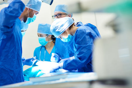 A young female surgical nurse in full PPE in surgery surgical theater operating room med surg nurse test bank