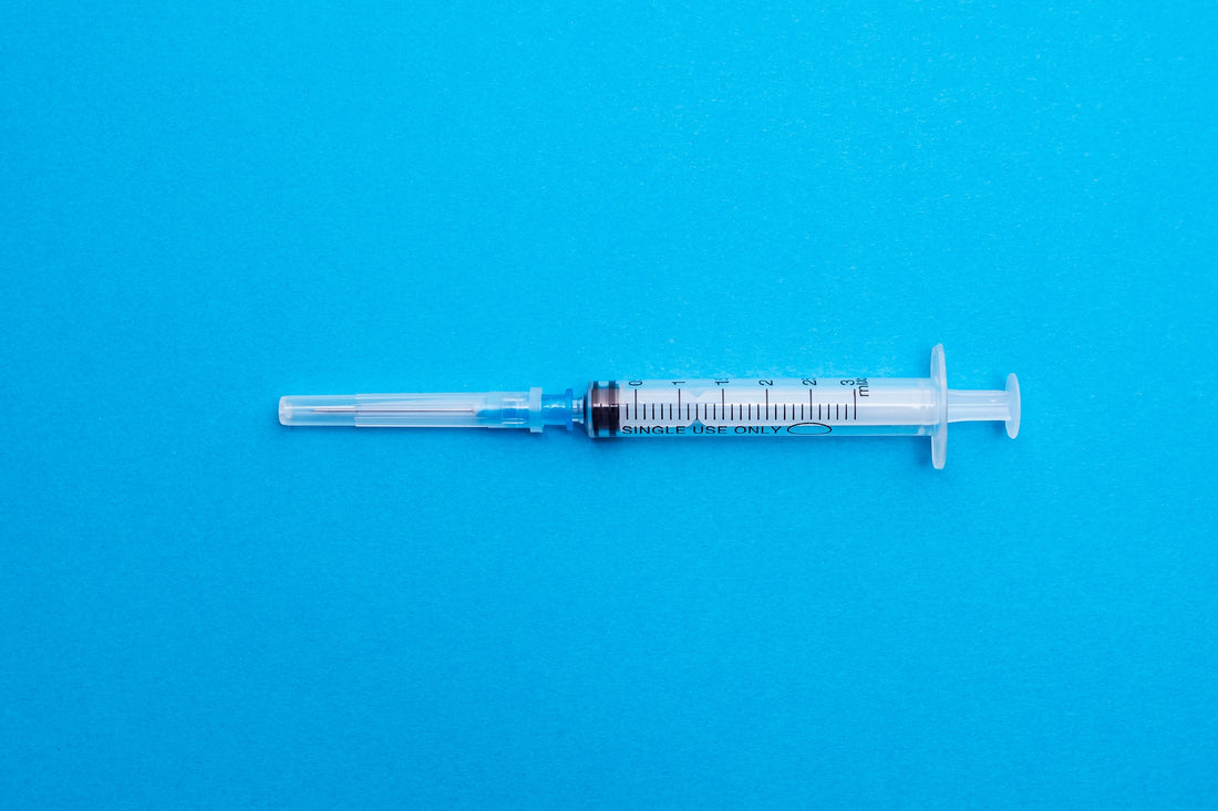 Syringe Closeup on blue background