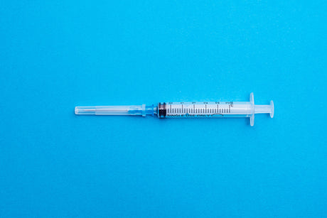 Syringe Closeup on blue background