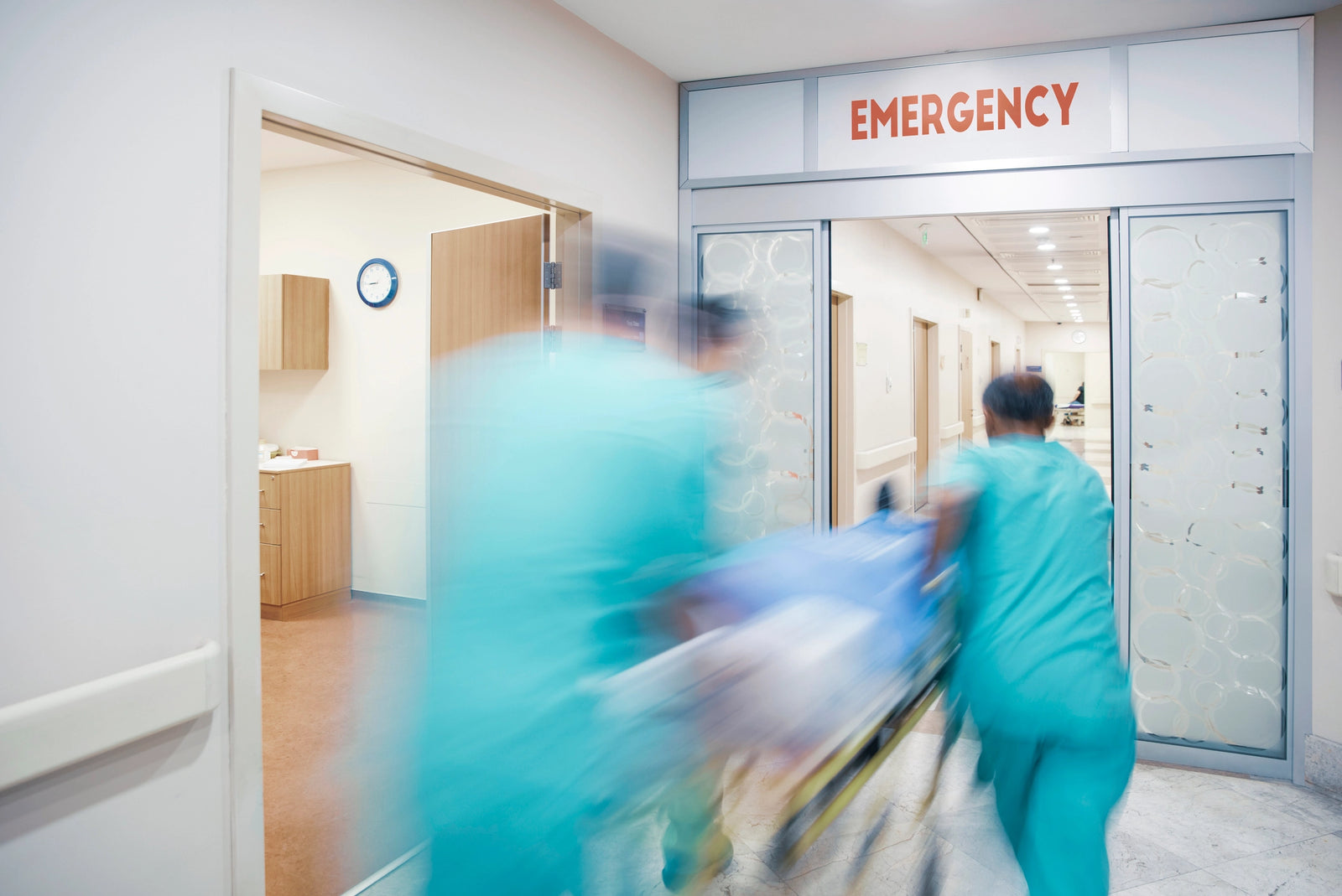 Trauma nurses rushing a stretcher down the ER hall