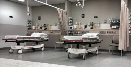 Two empty hospital beds in the ER ICU Pre-Operative Holding Area