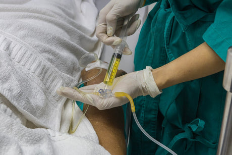 A nurse is giving and intravenous injection for the patient with IV fluid.