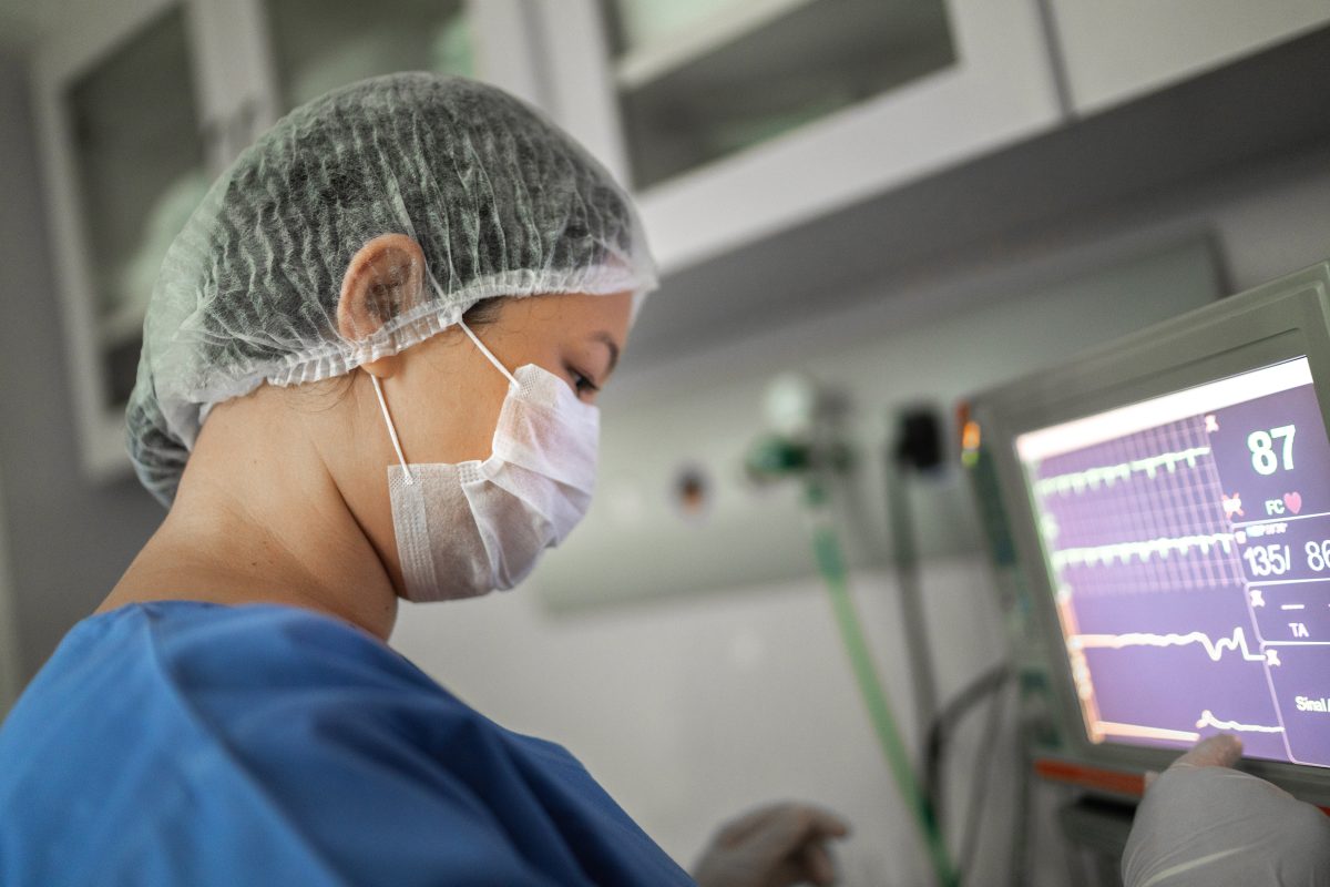 Anesthesiologist nurse watching computer monitor on a surgery in hospital