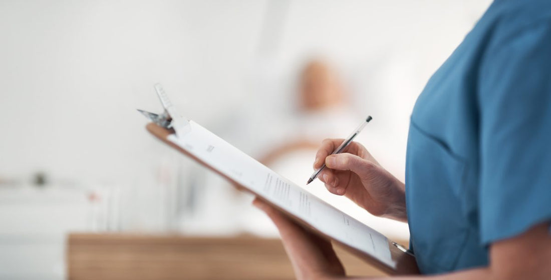 Nursing student taking psychiatric notes on a clipboard with a Bic pen.