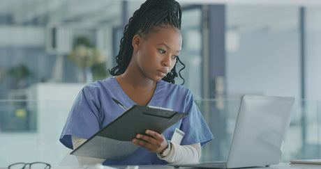 Black female African American young Nurse looking up free nursing care plans pdf