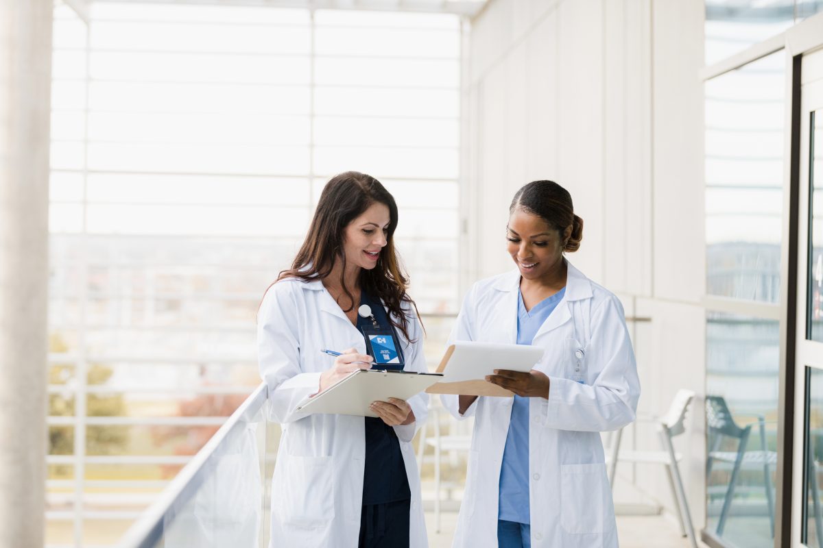 How to become a nurse practitioner title card with two nurses standing together