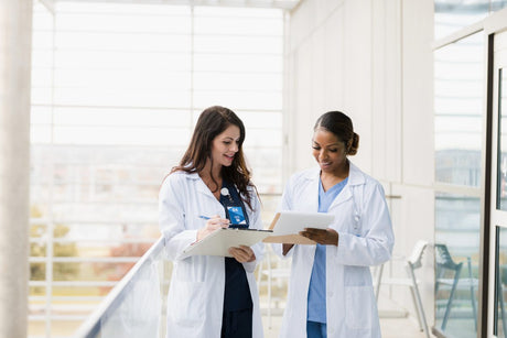 How to become a nurse practitioner title card with two nurses standing together