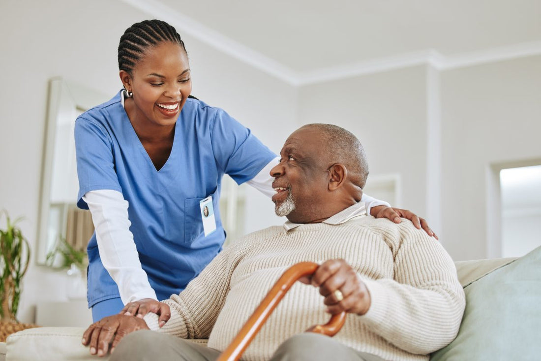 African American woman Nurse speaking to her male Black senior patient
