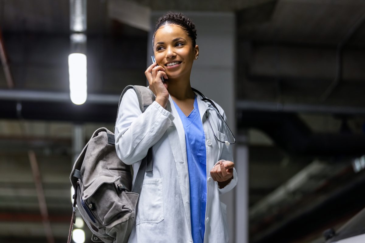Young Black African American female woman travel nurse talking on phone