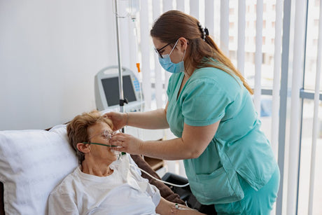 Nurse putting on a breathing mask on a female patient with covid-19.