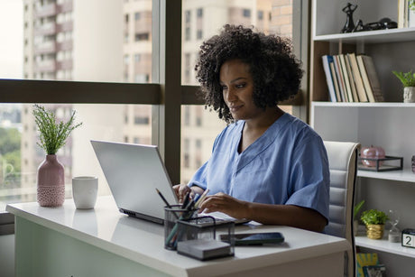 African American nurse working at her desk