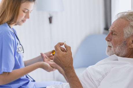 nurse giving tricyclic antidepressants to an reclining old man