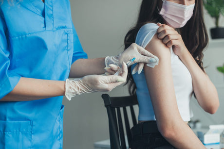 Nurse giving intramuscular injection (IM)