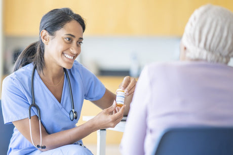 Nurse giving NSAIDs to patient