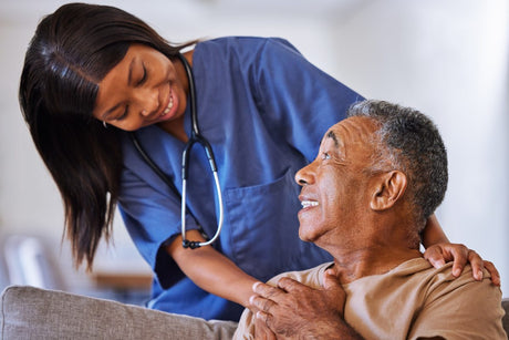 Beautiful African American Black nurse in hospice vs palliative care with a senior black man patient.