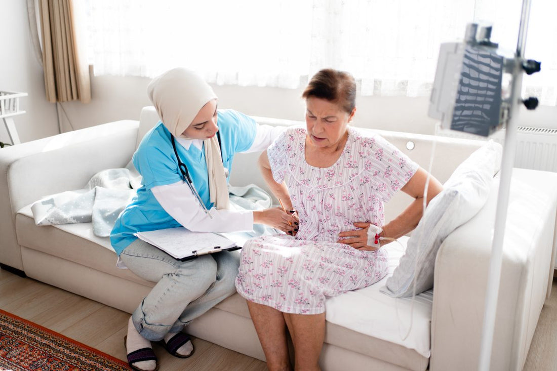Abdominal pain patient woman having medical exam with Muslim nurse on illness from stomach cancer, irritable bowel syndrome, pelvic discomfort, Indigestion, Diarrhea, GERD (gastro-esophageal reflux disease)