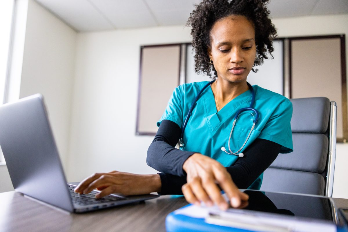 Female woman Black African American Nursing Medical student on laptop in classroom