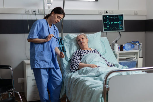 Nurse with patient going over ARDS stages with an elder senior woman patient in bed