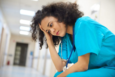 Emotional stress of young minority woman female nurse.