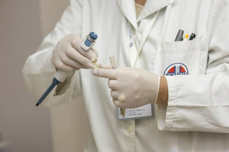 A hepatology nurse in a white lab coat