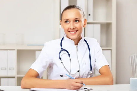 Smiling young female nurse making report sheet