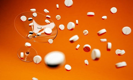 A martini glass flowing with white pills
